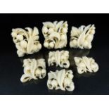 Seven carved ivory floral sprays that once formed a necklace