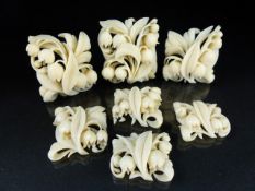 Seven carved ivory floral sprays that once formed a necklace