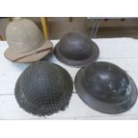 MILITARIA - Four military helmets to include a Fire Brigade helmet