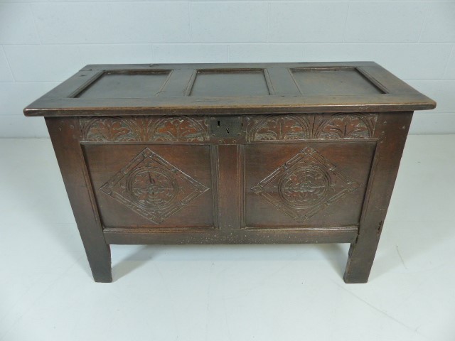 Antique carved coffer on plank feet