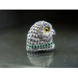 Silver owl shaped brooch with glass eye and an emerald collar