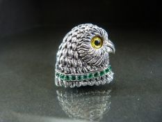 Silver owl shaped brooch with glass eye and an emerald collar