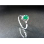 18ct white gold emerald and diamond cluster ring of 60pts