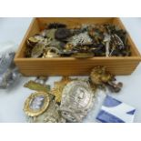 Wooden tray containing various cap badges