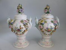Sitzendorf a pair of footed floral encrusted urns - both with twin blue handles and horse shoe trail