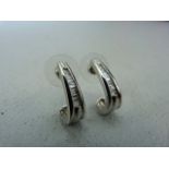 Pair of 14k White Gold earrings set with graduated baguette diamonds