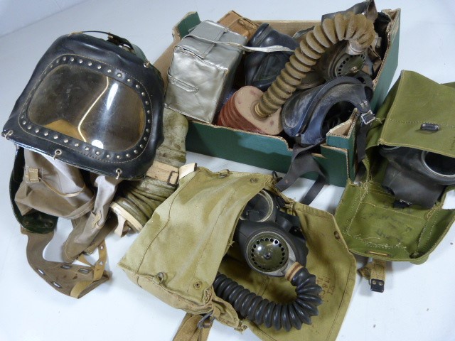 Box containing gas masks and various items from WW1 and WW2.