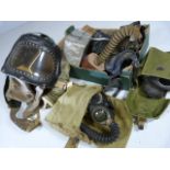 Box containing gas masks and various items from WW1 and WW2.