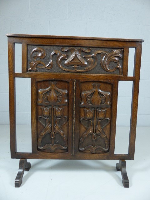 Arts and Crafts oak carved Fire screen - decorated with three panels depicting Tulips and pierced