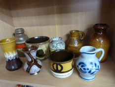Nine pieces of West German Pottery in varying sizes and Colours to include a Westerwald Jug