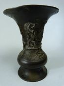 Oriental Bronze fluted vase carved in relief with Foo Dog and warrior with sword. Small amount of