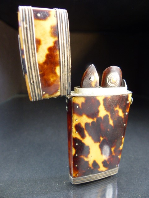 Tortoise shell miniature case containing small picks in folding cases.