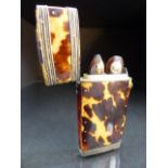 Tortoise shell miniature case containing small picks in folding cases.