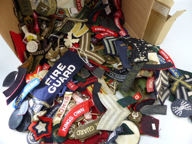 Box containing armbands and shoulder bands from various regiments