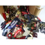 Box containing armbands and shoulder bands from various regiments