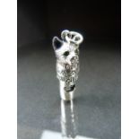 Silver whistle in the form of a cat with emerald eyes