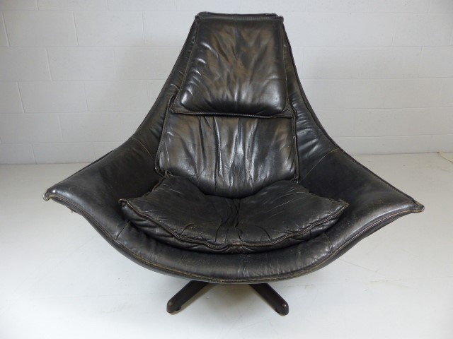 Mid Century large pointed black leather chair on wooden base