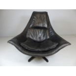 Mid Century large pointed black leather chair on wooden base