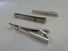 Two hallmarked silver Dunhill money clips along with a Michael Schumacher clip