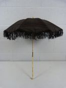 Victorian Mourning parasol in black the thin carved bone stem handle leading to a dogs head finial