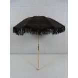 Victorian Mourning parasol in black the thin carved bone stem handle leading to a dogs head finial