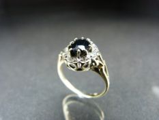 9ct gold ladies ring with dark coloured central stone