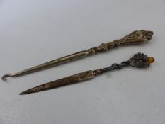 Hallmarked silver topped button hook, and a hallmarked silver paperknife set with the scottish