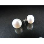 Cultured pearl earrings with silver backs.