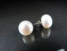 Cultured pearl earrings with silver backs.