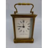 20th Century brass cased carriage clock with 5 glass panel and keys. Enamelled face with roman