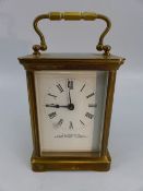 20th Century brass cased carriage clock with 5 glass panel and keys. Enamelled face with roman