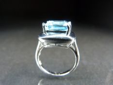 Silver dress ring set with a blue coloured stone. 6.1g