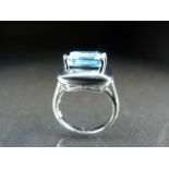 Silver dress ring set with a blue coloured stone. 6.1g