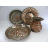 Middle Eastern copper wares to include Trays and an urn type jug