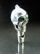 Silver (Sterling) whistle in the form of a skull with green eyes -