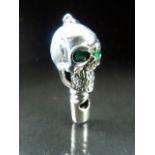 Silver (Sterling) whistle in the form of a skull with green eyes -