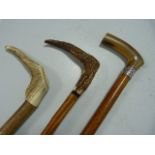 Three walking sticks - one with hallmarked silver band.