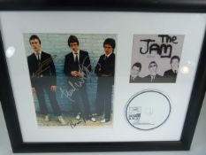 THE JAM - Mounted and framed signed photograph of the Jam by all three band members, frame also