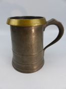 An unusual heavy pewter Quart mug, with brass rim.