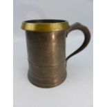 An unusual heavy pewter Quart mug, with brass rim.