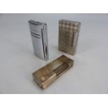 Two silver coloured DUPONT lighters and a dunhill lighter