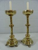 Brass antique Alter sticks on lion pad feet leading to twisted column and galleried bowl. The