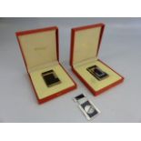 Two boxed DUPONT black and white lighters (Paris) with additional St DUPONT cigar lighter