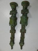 Pair of decorative plaster wall sconces in the form of ladies with crossed arms.