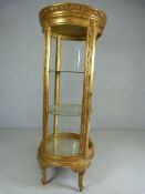 Circular french style display cabinet raised on four legs with Gilt decoration (missing two glass