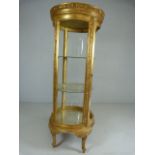 Circular french style display cabinet raised on four legs with Gilt decoration (missing two glass