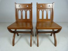 Ecclesiastic pair of chairs, with pierced work top and cross legs. C.19th century.