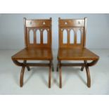 Ecclesiastic pair of chairs, with pierced work top and cross legs. C.19th century.