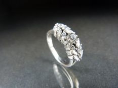 18ct White Gold Diamond ring. The central stone of 0.20pts approx and surrounded by dream cut