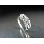 18ct White Gold Diamond ring. The central stone of 0.20pts approx and surrounded by dream cut